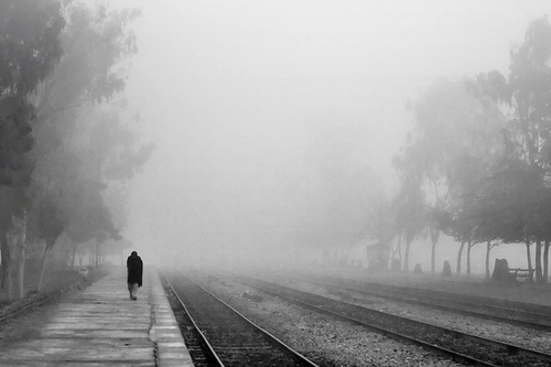 Returning from the fog, along train tracks