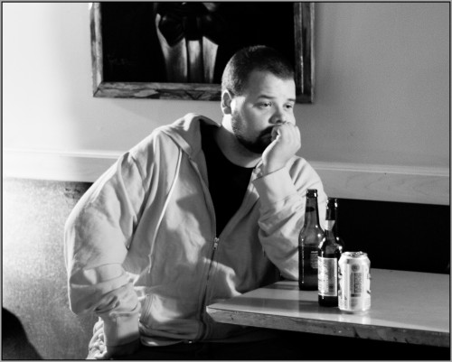 A man, stood up, waiting for his date the a bar
