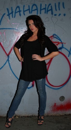 Attractive model behind "hahaha!!!" graffiti