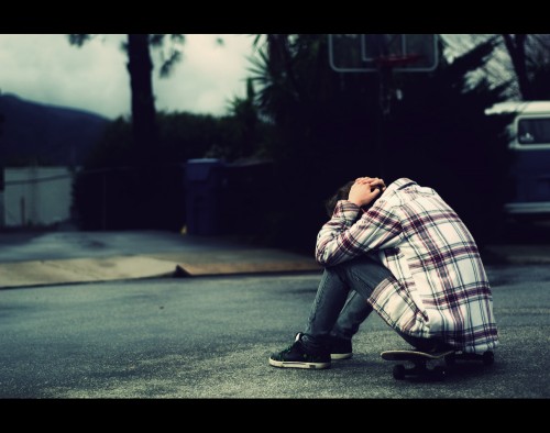 I ask you tonight. *EXPLORED A man, depressed, alone, sitting on a skateboard