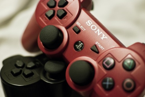 DualShock 3 A pair of Playstation Dual Shock Controllers, one in red