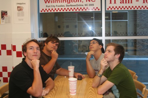 Four guys hanging out, thinking.