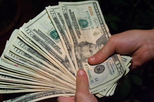 Money Bankroll Girls February 08, 20117 A woman holding a was of 20 dollar bills.