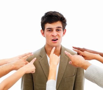 Women pointing to a professionally dressed man