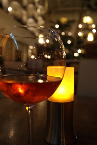 Red wine in a class, infront of a candle