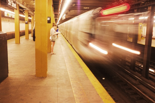 A woman, waiting for the N Train at 59th Street in NYC