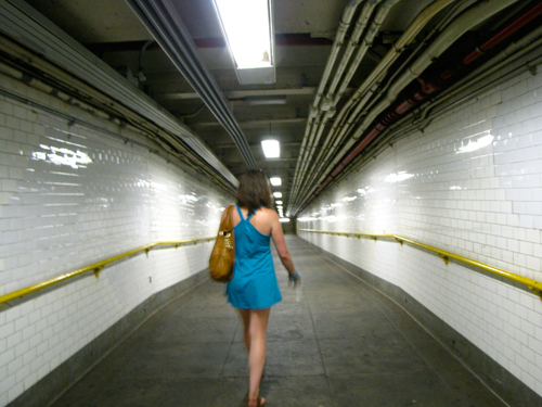 Lone Subway A woman walking down a subway tunnel to a train